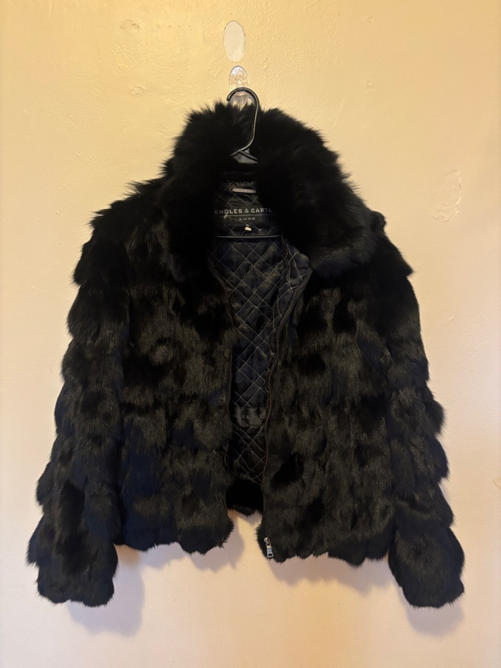 This garment is a vest or jacket made of genuine fox fur by the brand Knoles